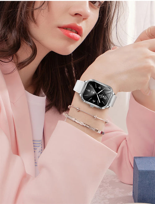 Woman wearing a smartwatch with a pink jacket and bracelets.